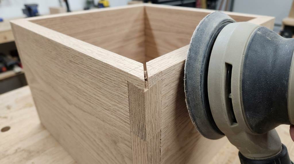 Sanding sticks and tools laid out for sanding tight corners on woodworking projects